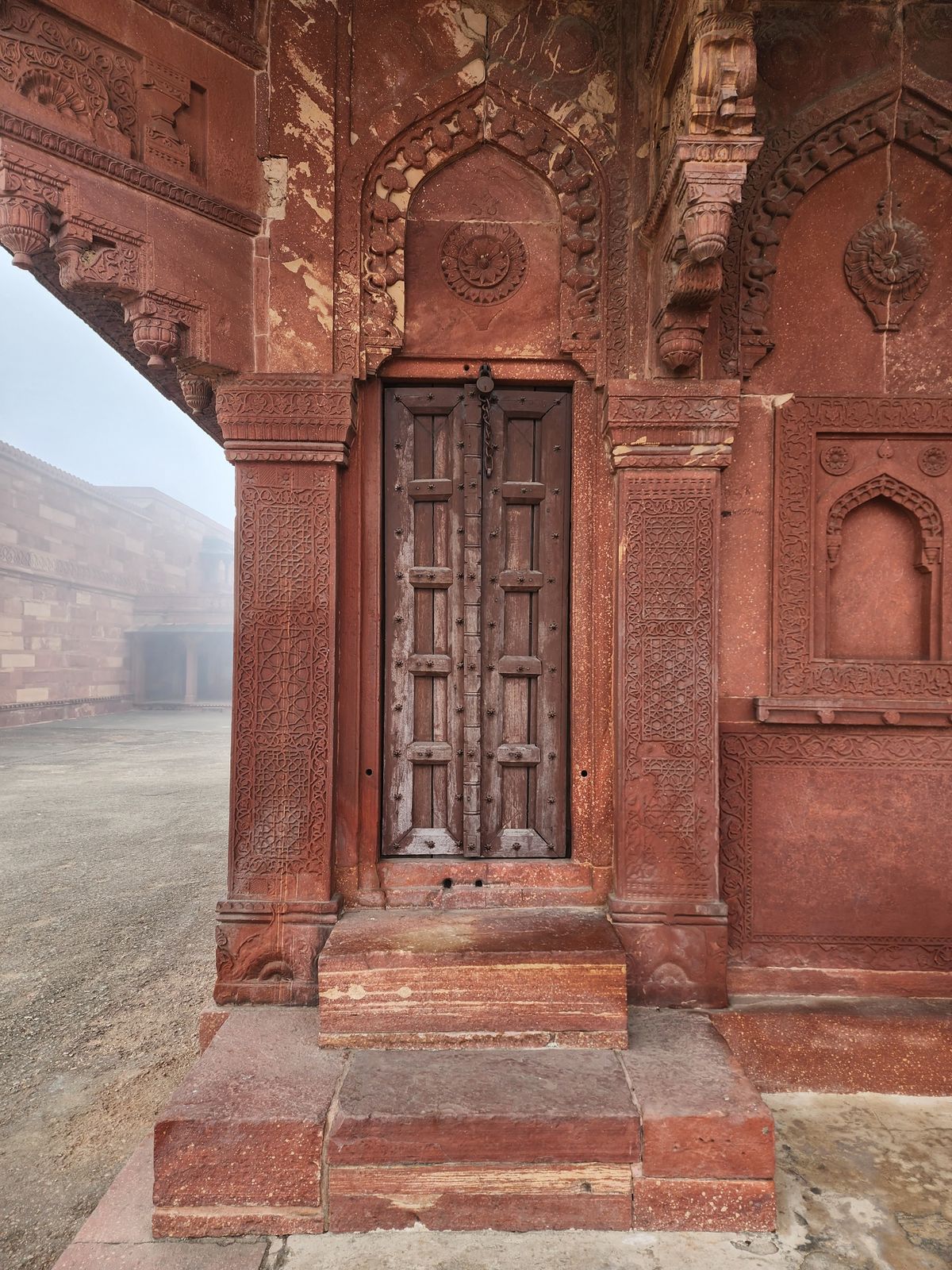 Representative photo: intricately carved red-sandstone doorway of a Mughal-era monument